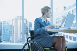 Cariati Law Toronto, Ontario Injury Lawyers Long Term Disability Lawyers Woman in Wheelchair working on laptop in Office