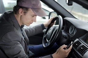 Cariati Law Toronto, Ontario Injury Lawyers Distracted Driving Lawyers Serious Injury Man Driving with cellphone