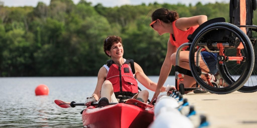 A woman with a spinal cord injury kayaking and enjoying the day.